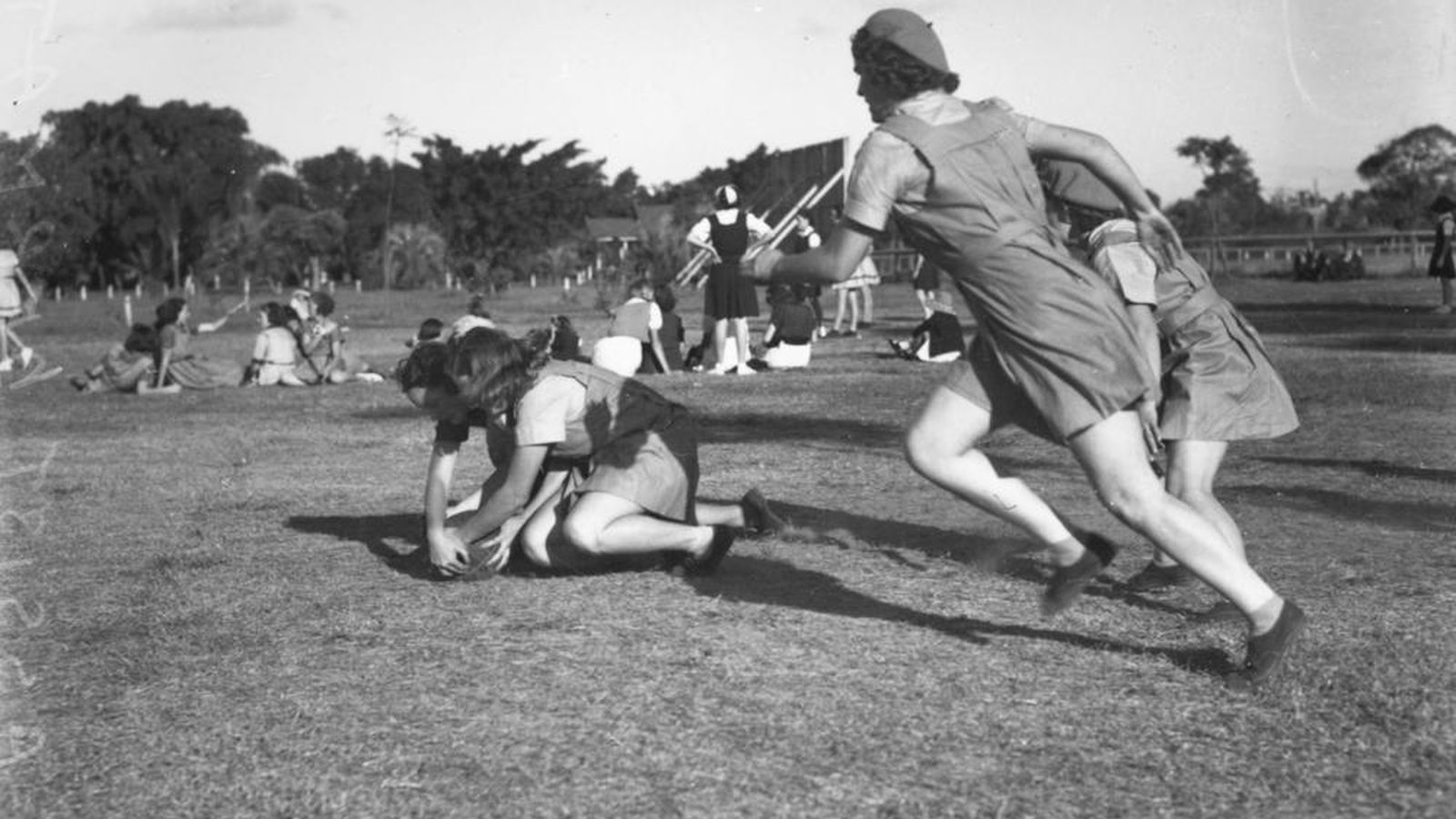 StateLibQld 1 105228 Girls wrestling over the ball during a netball game in Brisbane, 1940
